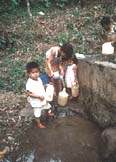 Filling jogs of water in Nicaragua - Click for info